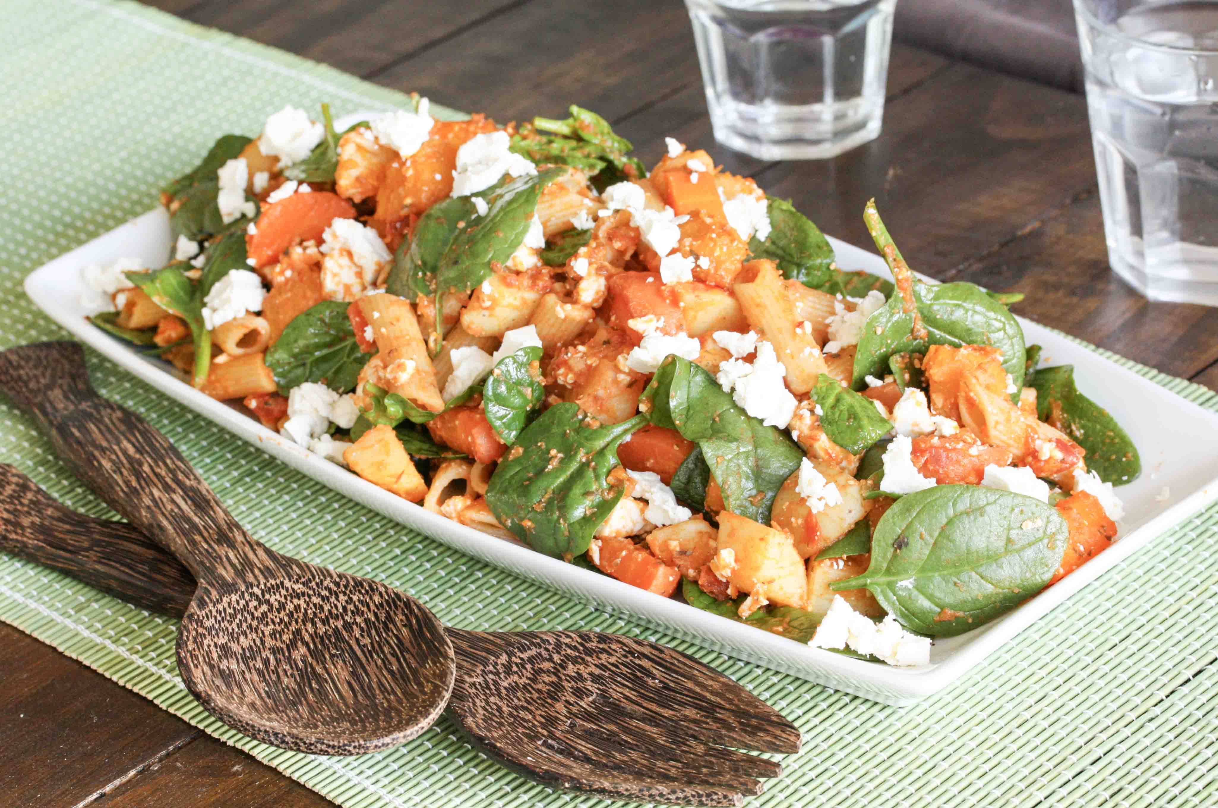 Pasta and roast root vegetables with sundried tomato sauce, baby spinach and feta