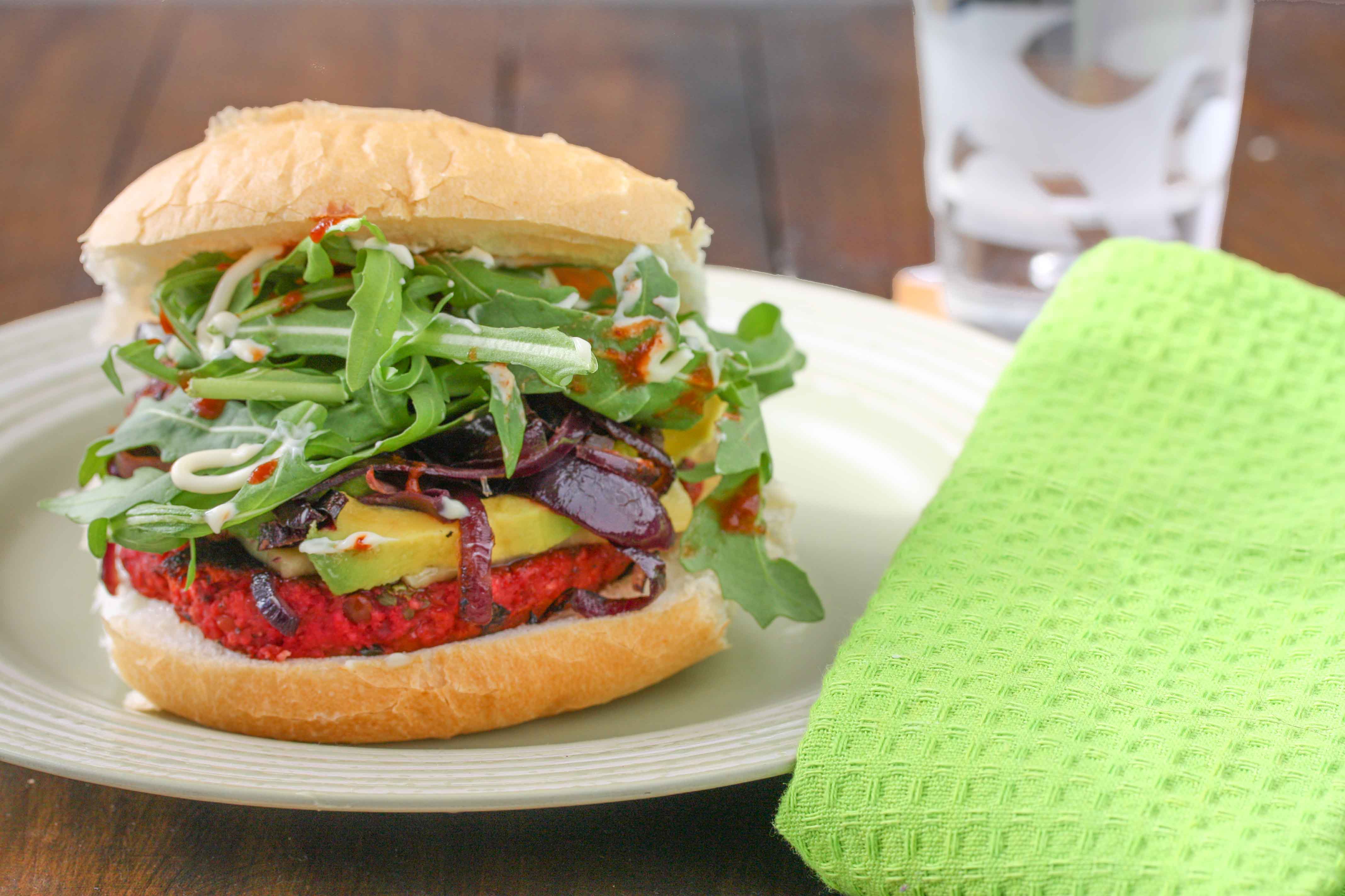 Beetroot, feta and lentil burgers with caramelised onion, avocado and rocket