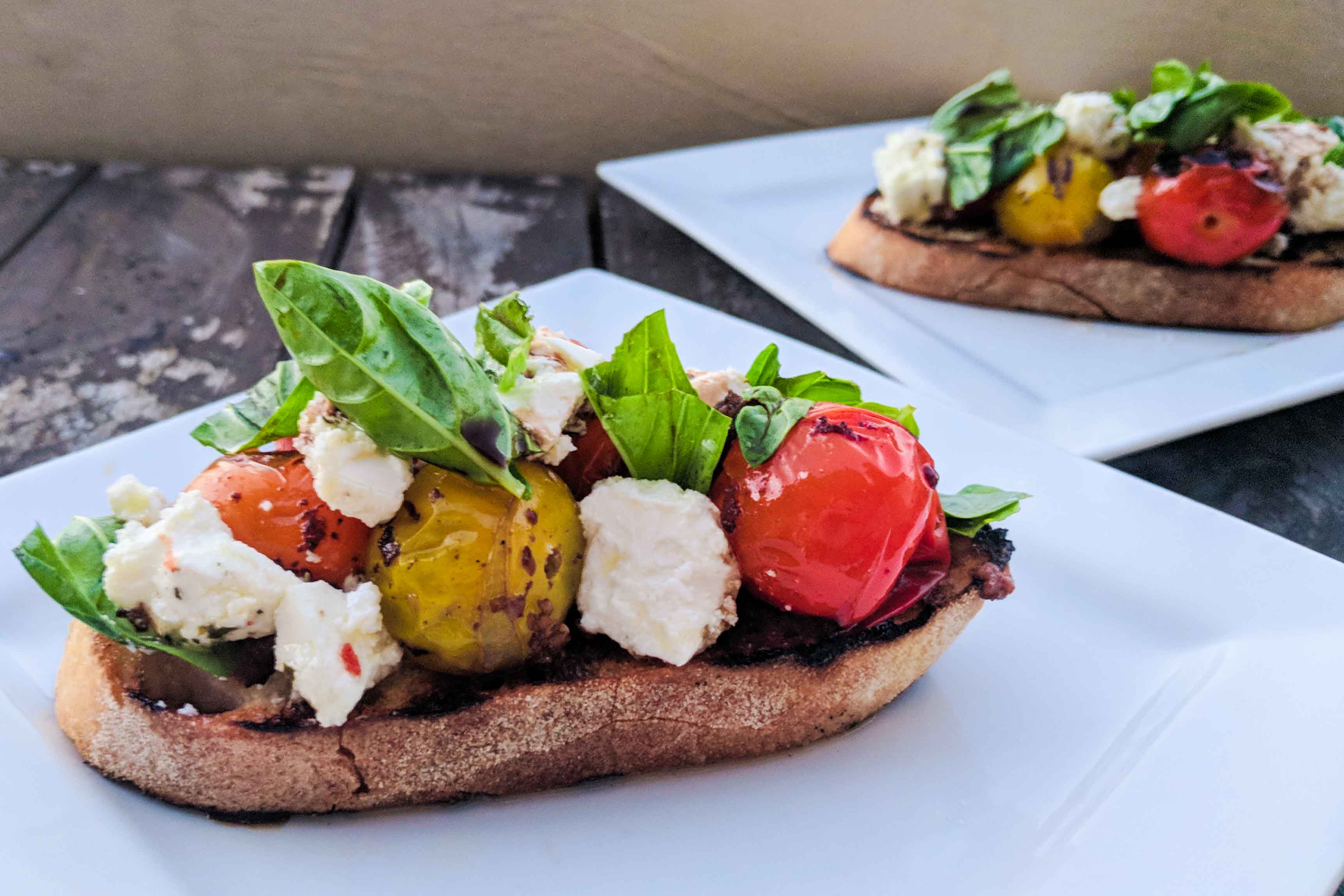 Barbecued heirloom tomato bruschetta with feta and basil